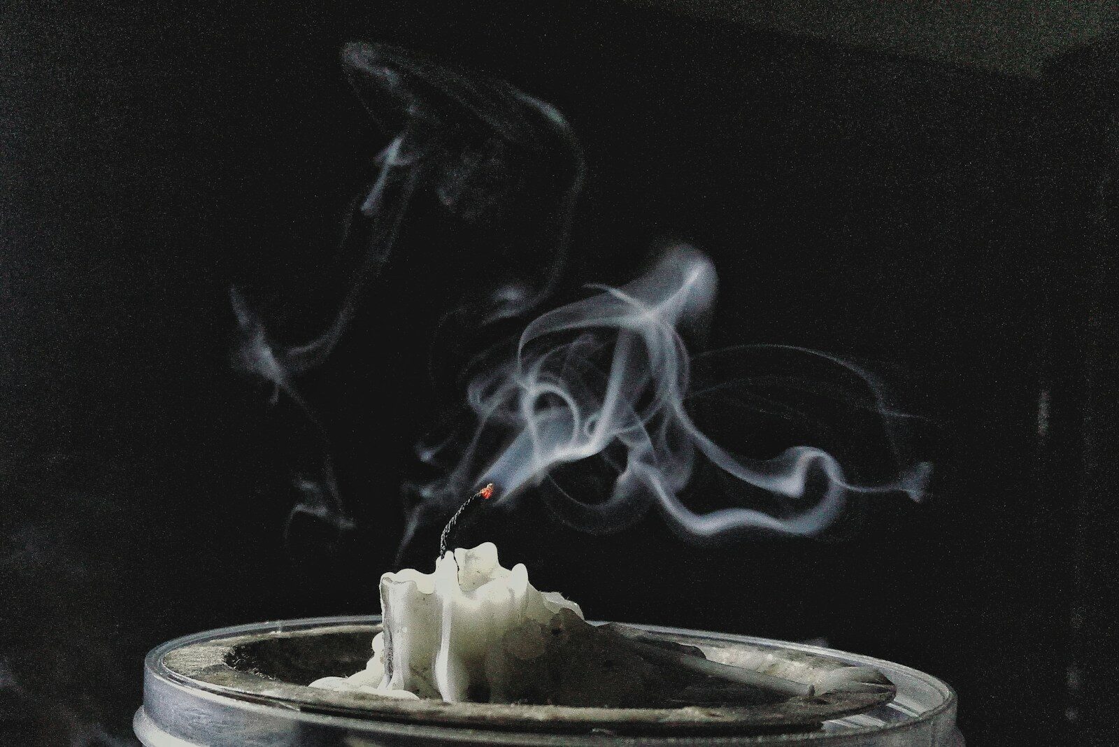 a candle with smoke coming out of it